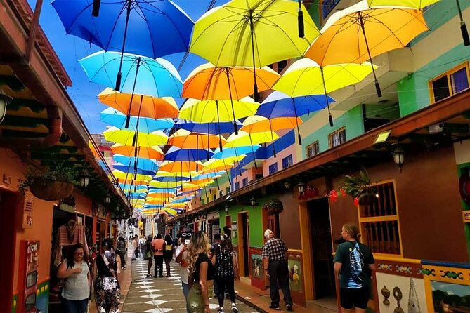 Customizable Guatapé and El Peñol Tour from Medellin - Guatapé town walk: painted streets, umbrellas, and a sea wall stroll