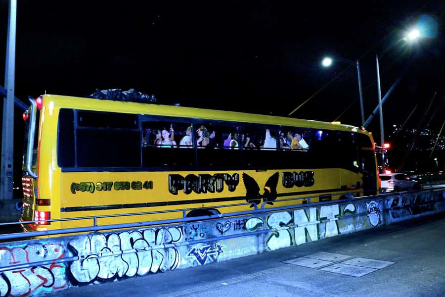 Medellin: Rumbero Party Bus with all the beer you can drink - Puente de la 4 Sur at night: architecture and lighting for photo time
